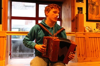 Resized image of Robert Creed, blind composer, playing button accordion