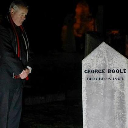 Michael Holland, University Curator paying respects at George Boole's grave